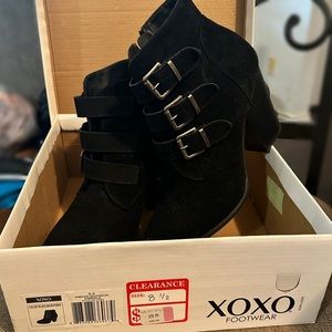 Black faux suede booties with buckles and side zip.